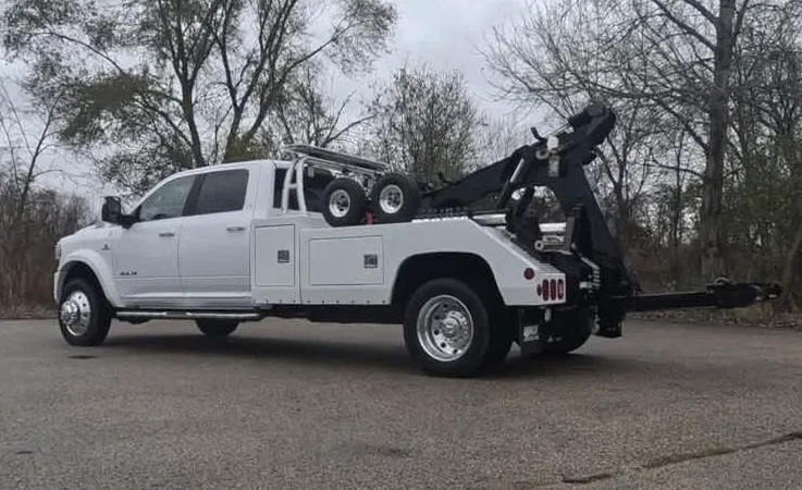 Surrey wrecker equipment securing damaged vehicle